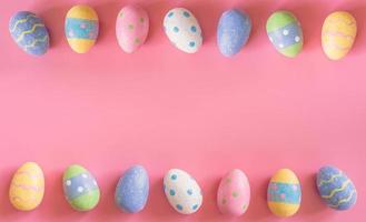 Colorful easter eggs on pink pastel color background with space. photo