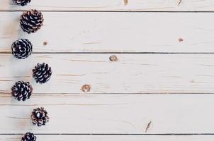 Pine cones on rusticwood white background with copy space, photo