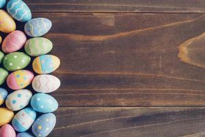 Top view of Easter eggs on rustic wood background with copy space photo