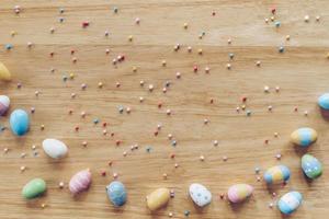 Easter eggs on on wood background top view with natural light. Flat lay style. photo
