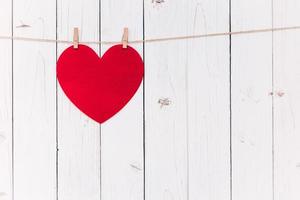 Blank red heart hanging on white wood with space for Valentine and Wedding background. photo