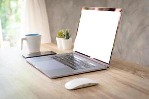 Laptop computer with blank screen on table. photo