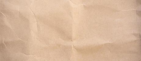Close up crumpled brown paper texture and background photo