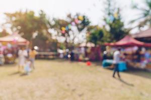 Abstract blur people and sunlight at festival in the city park garden with bokeh background. photo