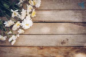 Flowers on old grunge wooden table texture and background with copy space. photo