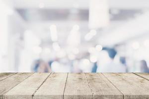 Empty wooden table with blurred abstract people on cafe on restaurant background. photo