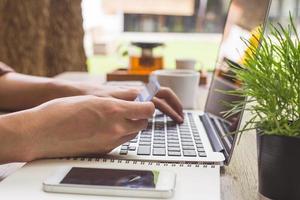 Man holding credit card and using laptop. Online shopping photo