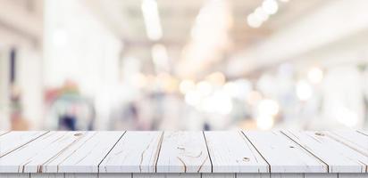 Empty wood table and blurred light table in shopping mall with bokeh background. product display template. photo