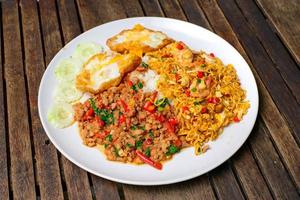 Fusion cuisine. Rice topped with stir-fried pork and basil with Stir fried instant noodle with mixed vegetable. photo