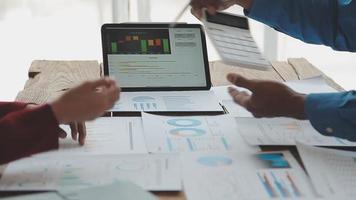 Financial analysts analyze business financial reports on a digital tablet planning investment project during a discussion at a meeting of corporate showing the results of their successful teamwork. video