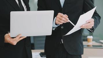 Financial analysts analyze business financial reports on a digital tablet planning investment project during a discussion at a meeting of corporate showing the results of their successful teamwork. video