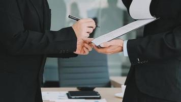 Financial analysts analyze business financial reports on a digital tablet planning investment project during a discussion at a meeting of corporate showing the results of their successful teamwork. video