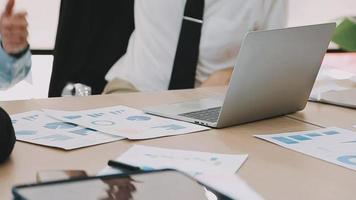 Financial analysts analyze business financial reports on a digital tablet planning investment project during a discussion at a meeting of corporate showing the results of their successful teamwork. video