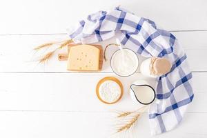 the spring holiday of the Jews of Shavuot. a festive card with traditional food and ears of corn. wooden white background. Top view. Copy space. photo