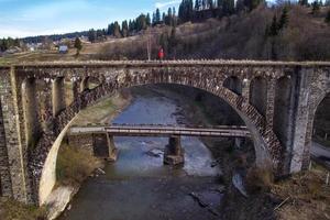 mujer en pie en ladrillo puente en dragobrat paisaje foto