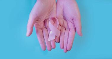 Woman hands holding a ribbon for World Cancer Day video