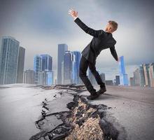 Businessman trying to overcome a deep break photo