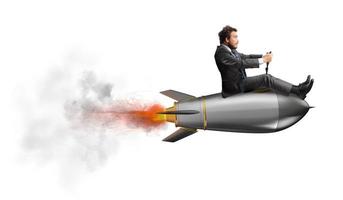 Businessman flying over a rocket. concept of company startup photo