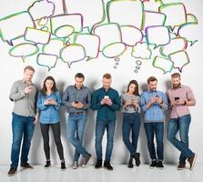 Group of boys and girls connected with their smartphones. Concept of internet and social network photo