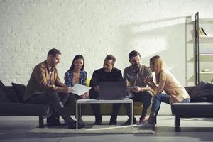 Business people connected on internet network with a laptop in a relax room. concept of startup company photo