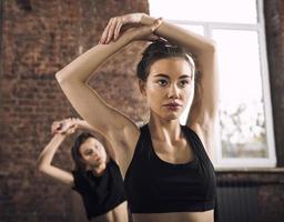 Friend girl do stretching at the gym photo