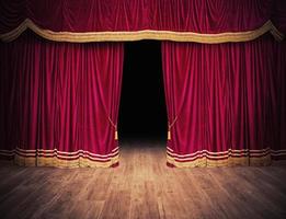 The red curtains are opening for the theater show photo