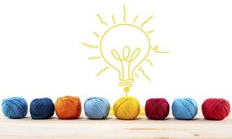 Concept of idea and innovation with wool ball that shapes a lightbulb photo