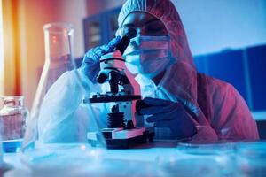 Doctor in the laboratory analyzes samples under a microscope. Pharmaceutical treatment concept. photo