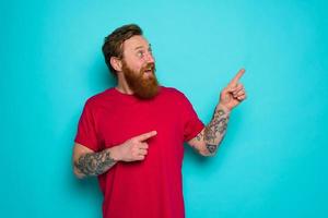 Man is wondered and indicates something with hand photo