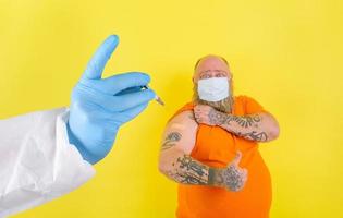 man with beard and tattoos does the vaccine against covid-19 photo