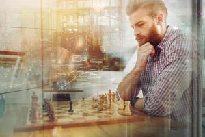 Businessmen play chess as strategy and tactic concept photo