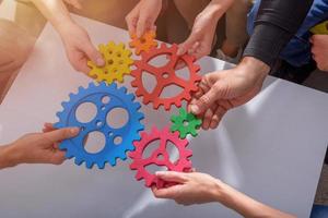 Business team connect pieces of gears like a teamwork and partners photo