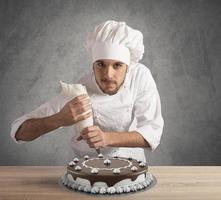 Pastry cook prepares a cake photo