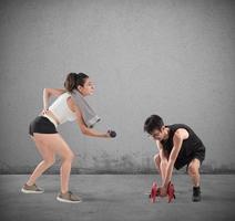 Boy and girl having difficulty at the gym photo