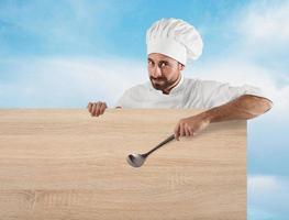 Chef with ladle and board photo