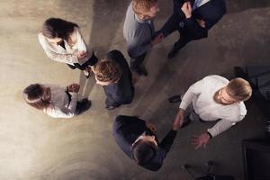 Handshaking business person in office. concept of teamwork and partnership. double exposure photo