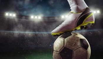 Close up of a soccer striker ready to kicks the ball at the stadium photo