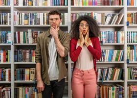 Young student with amazed expression in a library photo