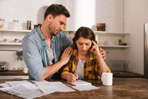 Couple have a problem with bills. Concept of economic trouble and failure photo