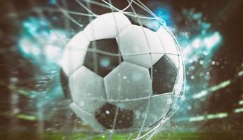 Close-up of a ball entering the net in a football match photo