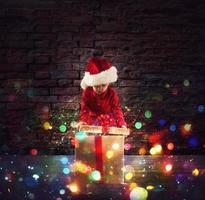 Happy little boy with a Christmas gift photo