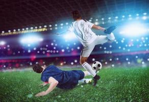 Football scene with competing football players at the stadium photo