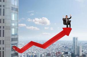 Businessman over a growing red statistic arrow. Concept of success photo