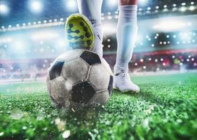 Close up of a soccer striker ready to kicks the ball at the stadium photo