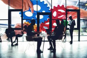 Business team connect pieces of gears. Teamwork, partnership and integration concept. double exposure with light effects photo