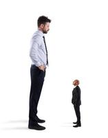 Small businessman terrified by his big boss photo