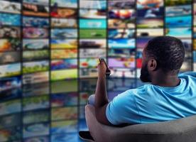 Man has fun watching a film. Concept of entertainment and streaming tv. red background photo