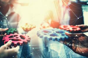 Business team connect pieces of gears. Teamwork, partnership and integration concept. double exposure with network effects photo