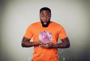 Man holds a piggy bank that cry because it is without any money photo