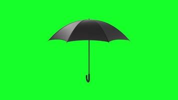 Black umbrella isolated on green background video